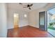 Bedroom featuring wood floors, ceiling fan, and backyard access at 2585 Portsmouth Creek Ave, Henderson, NV 89052