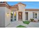 Inviting front entrance featuring desert landscaping, tile roof, and tan stucco at 2585 Portsmouth Creek Ave, Henderson, NV 89052