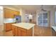 Well-appointed kitchen with island and view of living room with fireplace at 2585 Portsmouth Creek Ave, Henderson, NV 89052
