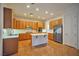 Modern kitchen with stainless steel appliances, central island, and ample cabinet space at 2585 Portsmouth Creek Ave, Henderson, NV 89052