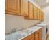 Bright laundry room with ample storage cabinets and a sink at 2585 Portsmouth Creek Ave, Henderson, NV 89052