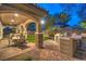 Covered outdoor patio with stone columns, seating area, outdoor kitchen and barbecue, perfect for entertaining at 2800 Proust Ct, Henderson, NV 89044
