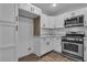 Kitchen with white cabinets, stainless steel appliances, and wood flooring at 2851 S Valley View Blvd # 1098, Las Vegas, NV 89102