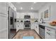 Staged kitchen with white cabinets, stainless steel appliances, and marble countertops at 2851 S Valley View Blvd # 1098, Las Vegas, NV 89102