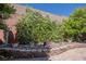 Lush backyard featuring flowering bushes and stone-lined flower beds and trees at 7119 Saddle Back Peak St, Las Vegas, NV 89166