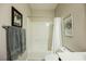 Bright bathroom featuring a shower-tub combination with white tile surround and neutral wall paint at 7119 Saddle Back Peak St, Las Vegas, NV 89166