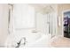 Bright bathroom featuring a tub with glass shower, plantation shutters, and ample natural light at 7119 Saddle Back Peak St, Las Vegas, NV 89166