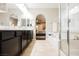 Stylish bathroom featuring dual sink vanity, a soaking tub and separate shower, all with clean lines at 7119 Saddle Back Peak St, Las Vegas, NV 89166