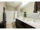 Bathroom features dual sinks, vanity, mirror, tub and shower combo at 7119 Saddle Back Peak St, Las Vegas, NV 89166
