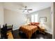 This is a bedroom with neutral wall paint, dark wood floors, window with shutters, and a ceiling fan at 7119 Saddle Back Peak St, Las Vegas, NV 89166