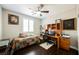 Bright bedroom with a ceiling fan, wood flooring, and natural light at 7119 Saddle Back Peak St, Las Vegas, NV 89166
