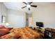 Comfortable bedroom with dark wood floors, ceiling fan, and white closet doors for ample storage at 7119 Saddle Back Peak St, Las Vegas, NV 89166