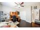 Bright bedroom with a ceiling fan, desk area and wood flooring at 7119 Saddle Back Peak St, Las Vegas, NV 89166