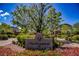 Attractive community entrance featuring colorful flowers, manicured greenery, and brick signage for The Promenade at Providence at 7119 Saddle Back Peak St, Las Vegas, NV 89166