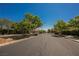 View of the entrance to the Providence neighborhood featuring lush green trees and landscaping at 7119 Saddle Back Peak St, Las Vegas, NV 89166