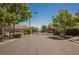 Gated entrance to the Providence community; lush trees and landscaping with an iron gate at 7119 Saddle Back Peak St, Las Vegas, NV 89166