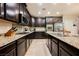 Stylish kitchen showcasing granite countertops, modern appliances, and dark wood cabinetry at 7119 Saddle Back Peak St, Las Vegas, NV 89166