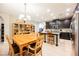 Well-lit kitchen and dining area featuring a large island and a view of the kitchen appliances at 7119 Saddle Back Peak St, Las Vegas, NV 89166
