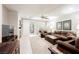 Comfortable living room features tile floors, ceiling fan, fireplace, and sliding glass doors to a patio at 7119 Saddle Back Peak St, Las Vegas, NV 89166