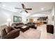 Spacious living room featuring a ceiling fan and seamless flow to the dining area and kitchen at 7119 Saddle Back Peak St, Las Vegas, NV 89166