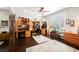 Well-lit home office with built-in desk, shelving, hardwood floors, and plantation shutters at 7119 Saddle Back Peak St, Las Vegas, NV 89166
