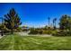 Beautiful park featuring green grass, trees, and a playground area for community enjoyment and recreation at 7119 Saddle Back Peak St, Las Vegas, NV 89166