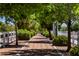 Scenic walking path lined with trees and white fences offers a tranquil space for neighborhood residents to exercise at 7119 Saddle Back Peak St, Las Vegas, NV 89166