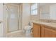 Cozy bathroom features a shower, and vanity with a granite countertop at 7711 Lofty Hill Ct, Las Vegas, NV 89123