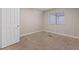 Neutral bedroom has carpet flooring, blank walls, and a window at 7711 Lofty Hill Ct, Las Vegas, NV 89123