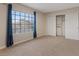 Bedroom featuring neutral walls, plush carpeting, and an opened closet at 7711 Lofty Hill Ct, Las Vegas, NV 89123