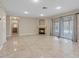 Bright living room boasts tile flooring, neutral walls, and a fireplace at 7711 Lofty Hill Ct, Las Vegas, NV 89123