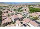 Wide angle rooftop community shot with mountain backdrop showing terracotta tile roofs, mature landscaping, and neighborhood streets at 1024 Larkspur Point Ct, Las Vegas, NV 89138