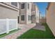 A spacious backyard with a paver patio, artificial turf, and access to the house, perfect for outdoor activities at 1024 Larkspur Point Ct, Las Vegas, NV 89138