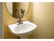 Powder room featuring pedestal sink, modern faucet, and round mirror at 1024 Larkspur Point Ct, Las Vegas, NV 89138