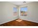 Bedroom featuring hardwood floors, base molding, and dual windows with outside views at 1024 Larkspur Point Ct, Las Vegas, NV 89138