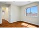 Well-lit bedroom featuring hardwood floors and a view of the neighborhood at 1024 Larkspur Point Ct, Las Vegas, NV 89138