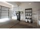 View of the garage featuring a water filtration system and storage shelving, offering practical space for storage and utilities at 1024 Larkspur Point Ct, Las Vegas, NV 89138