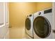Well-lit laundry room includes front loading washer and dryer at 1024 Larkspur Point Ct, Las Vegas, NV 89138