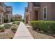 A well-maintained walkway leads to the home, lined with manicured bushes and rocks at 1024 Larkspur Point Ct, Las Vegas, NV 89138