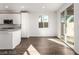 Modern kitchen flowing into adjacent living space with stainless appliances and tile flooring at 10328 Apefly St, Las Vegas, NV 89141