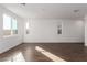 Open-concept living space with wood-look tile, ample natural light, and modern design at 10328 Apefly St, Las Vegas, NV 89141