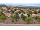 Expansive aerial view of a residential neighborhood with well-manicured lawns and mountain views at 11013 Mission Lakes Ave, Las Vegas, NV 89134