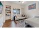 Cozy bedroom features a comfortable couch, modern decor, a large window, and hardwood floors at 11013 Mission Lakes Ave, Las Vegas, NV 89134