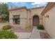 Charming single-story home featuring an arched entryway, well-maintained landscaping, and a stone walkway at 11013 Mission Lakes Ave, Las Vegas, NV 89134