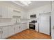 Modern kitchen boasts white cabinets, stainless steel appliances, and bright lighting at 11013 Mission Lakes Ave, Las Vegas, NV 89134