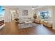 Open concept living room featuring hardwood floors, modern furniture, a fireplace, and backyard access at 11013 Mission Lakes Ave, Las Vegas, NV 89134