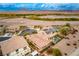 Stunning aerial view of homes with pools and solar panels backed by desert landscape at 1172 Via Della Costrella, Henderson, NV 89011