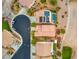 Aerial view showcasing a neighborhood with a pool, solar panels, and well-manicured lawns at 1172 Via Della Costrella, Henderson, NV 89011
