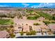 Wide aerial shot of a community homes with golf course and desert landscape views at 1172 Via Della Costrella, Henderson, NV 89011