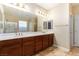 Bright bathroom features double sinks, a large mirror, and tiled floors, creating a functional and stylish space at 1172 Via Della Costrella, Henderson, NV 89011